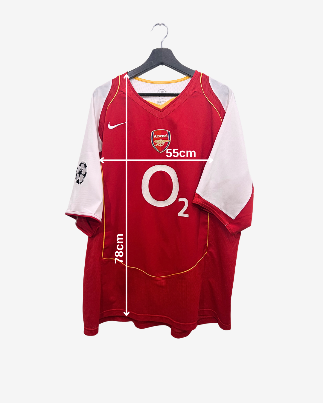 Red sports jersey with white sleeves on a hanger, showing measurements.