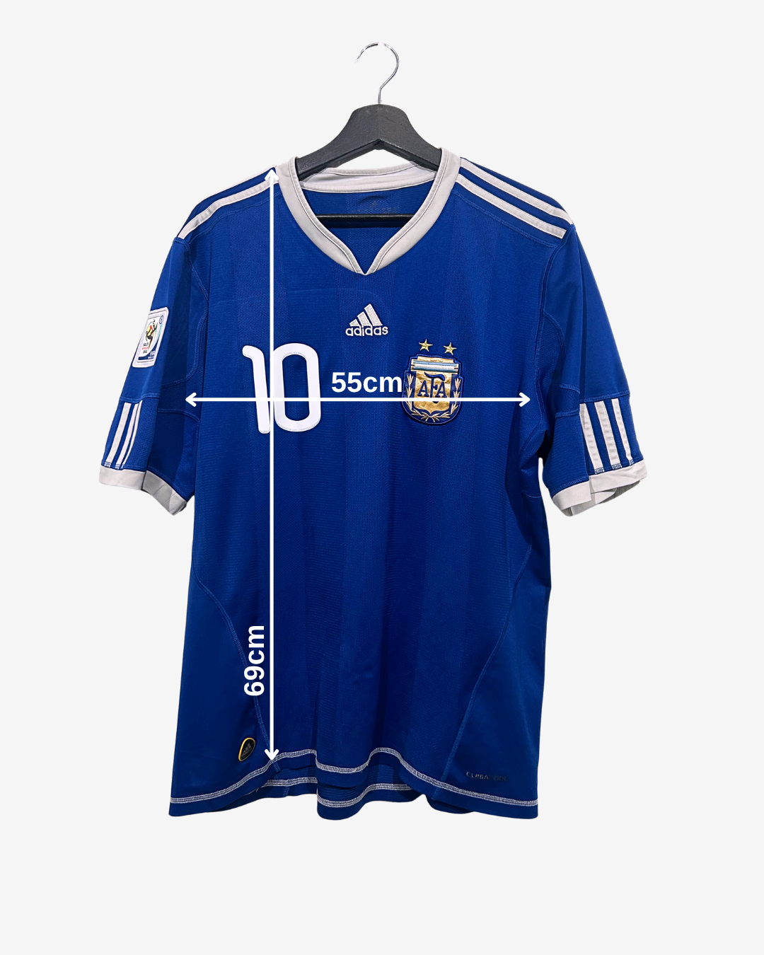 Blue sports jersey with white accents on a hanger, showing measurements.
