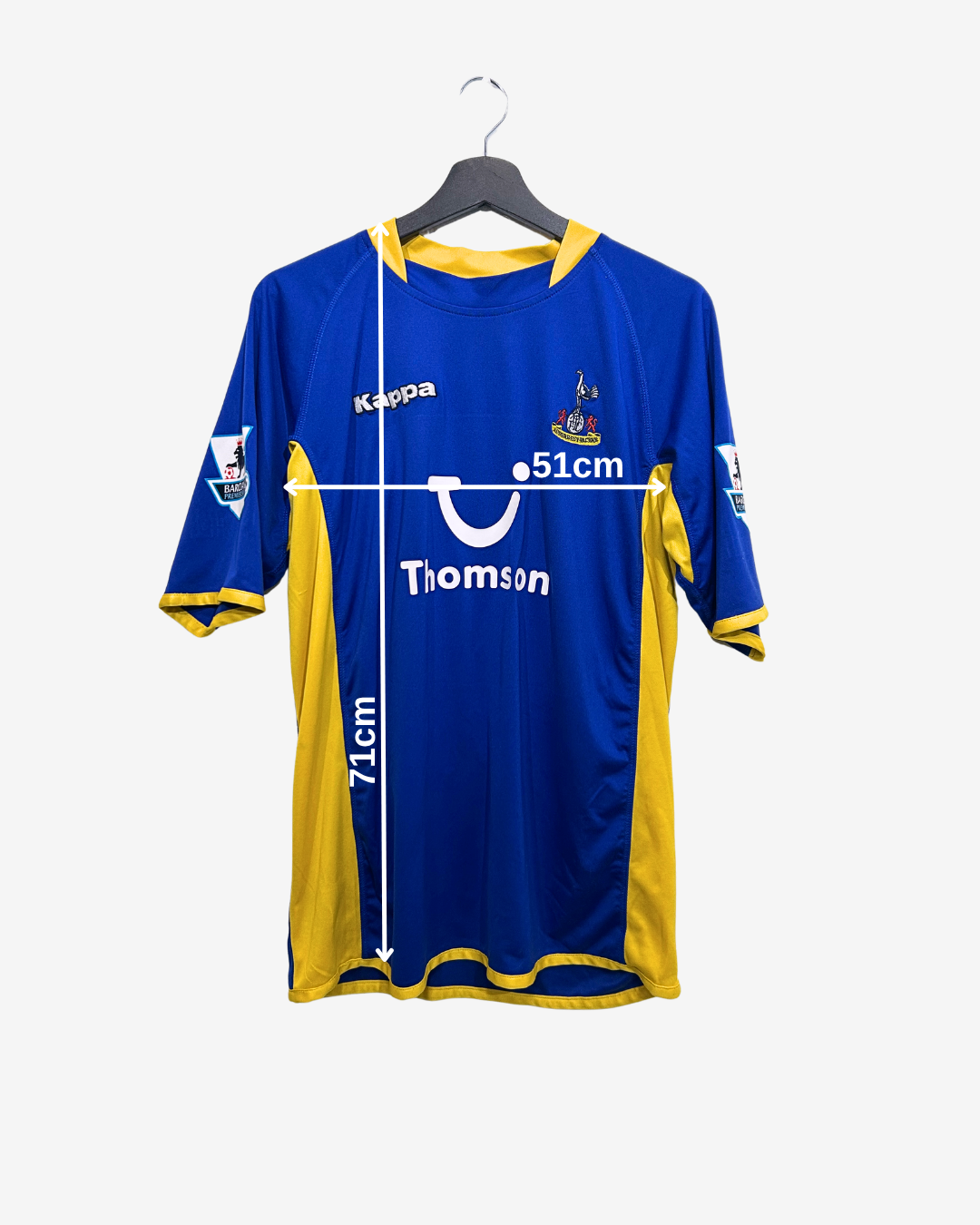 Blue and yellow sports jersey on a hanger with brand logos.
