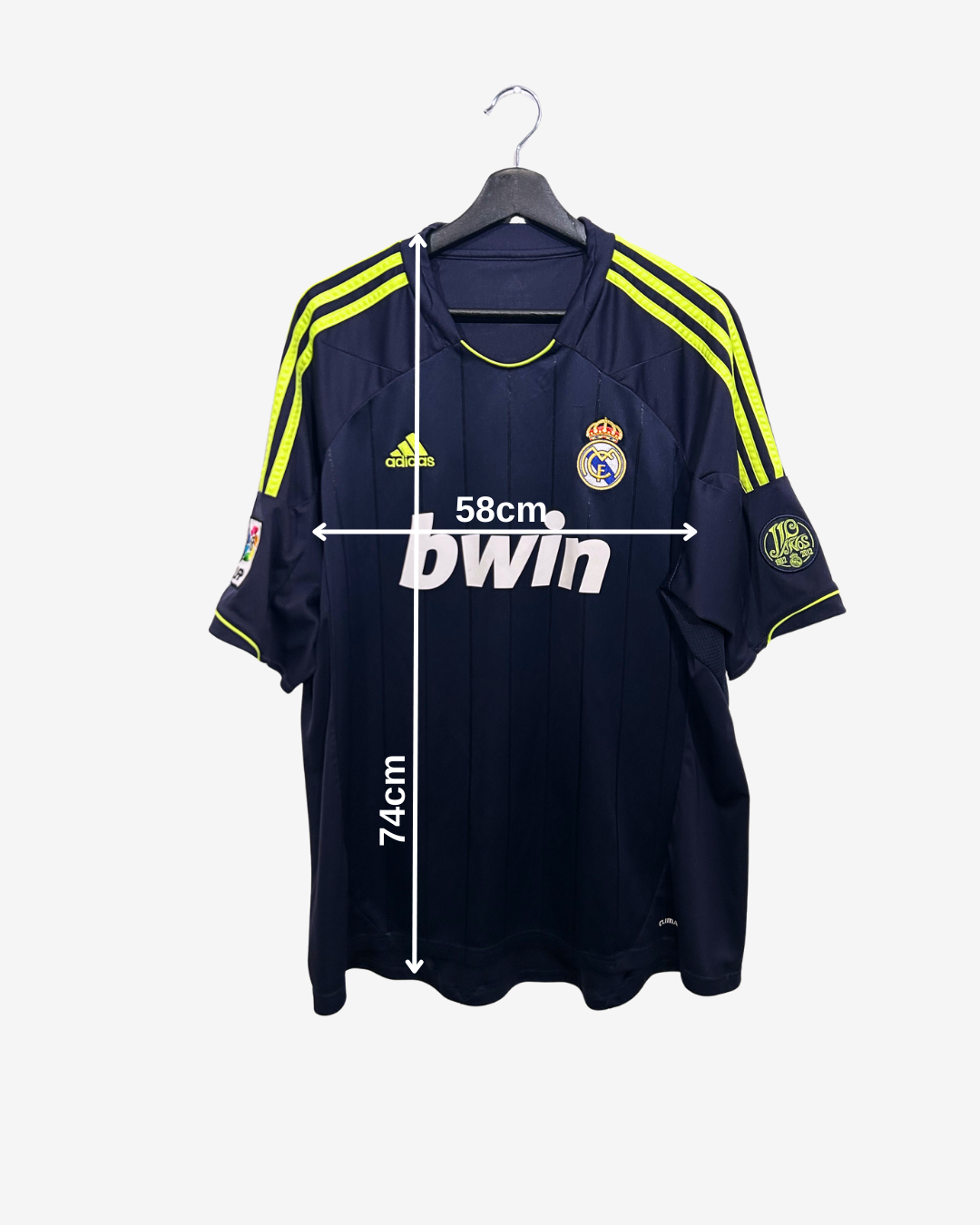Real Madrid jersey on a hanger with measurements and branding displayed