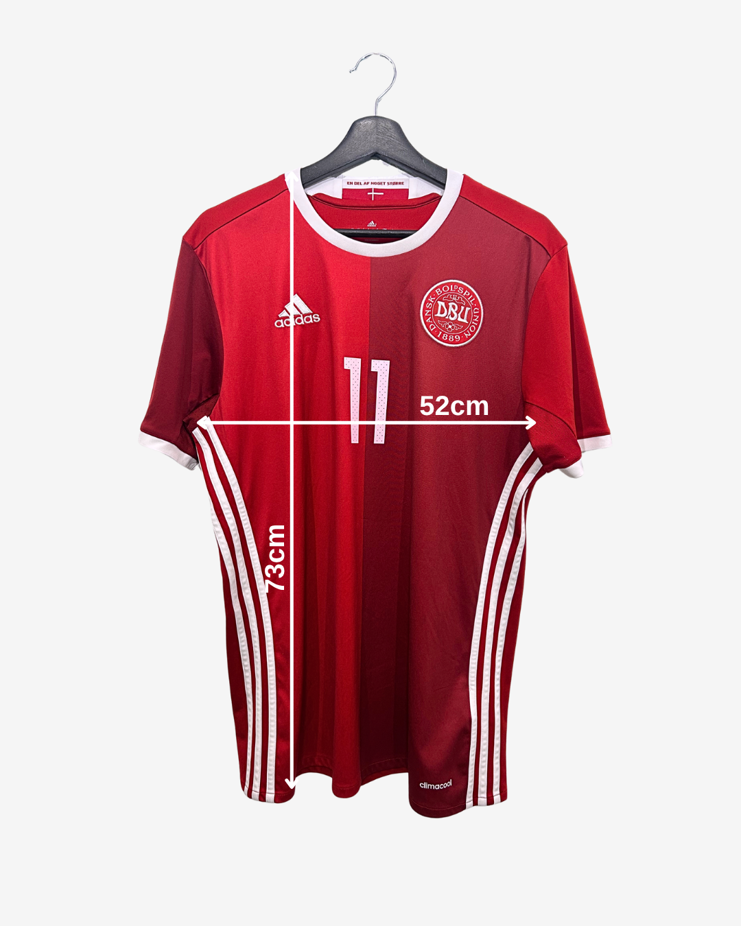 Red sports jersey with white accents on a hanger, showing measurements.