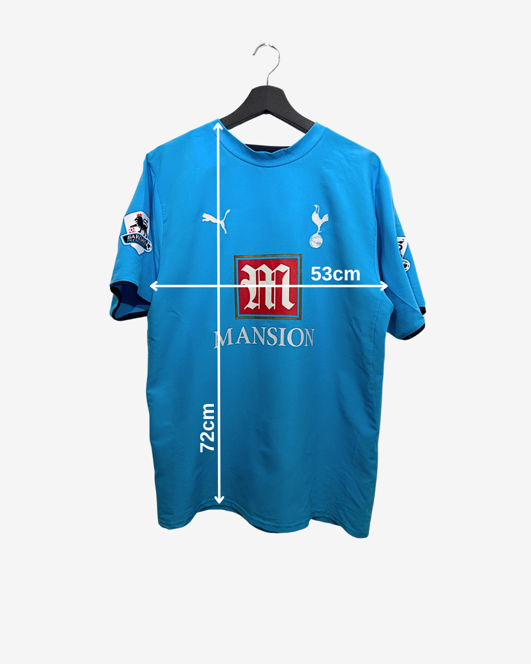 Blue sports jersey with measurements and logos on a white background