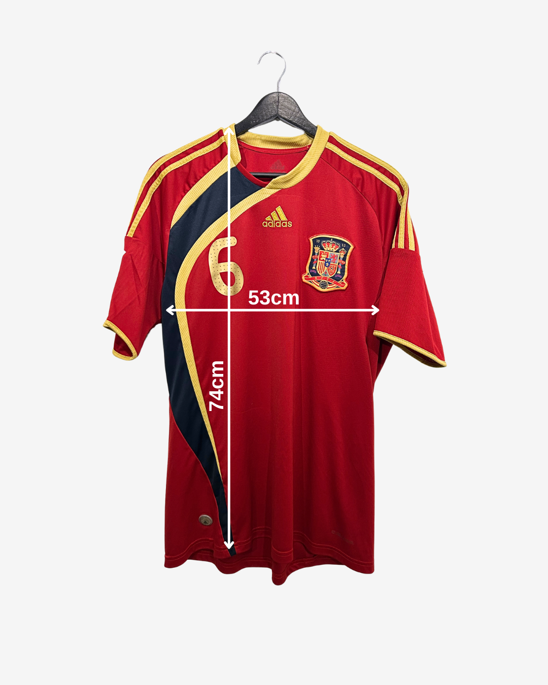 Red sports jersey with measurements on a hanger