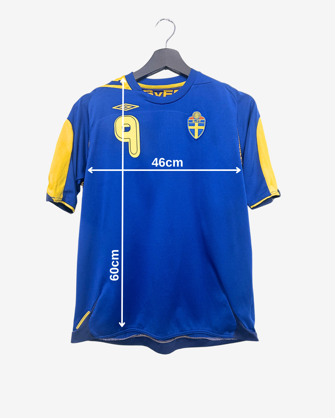 Blue sports jersey with yellow sleeves on a hanger, showing measurements.