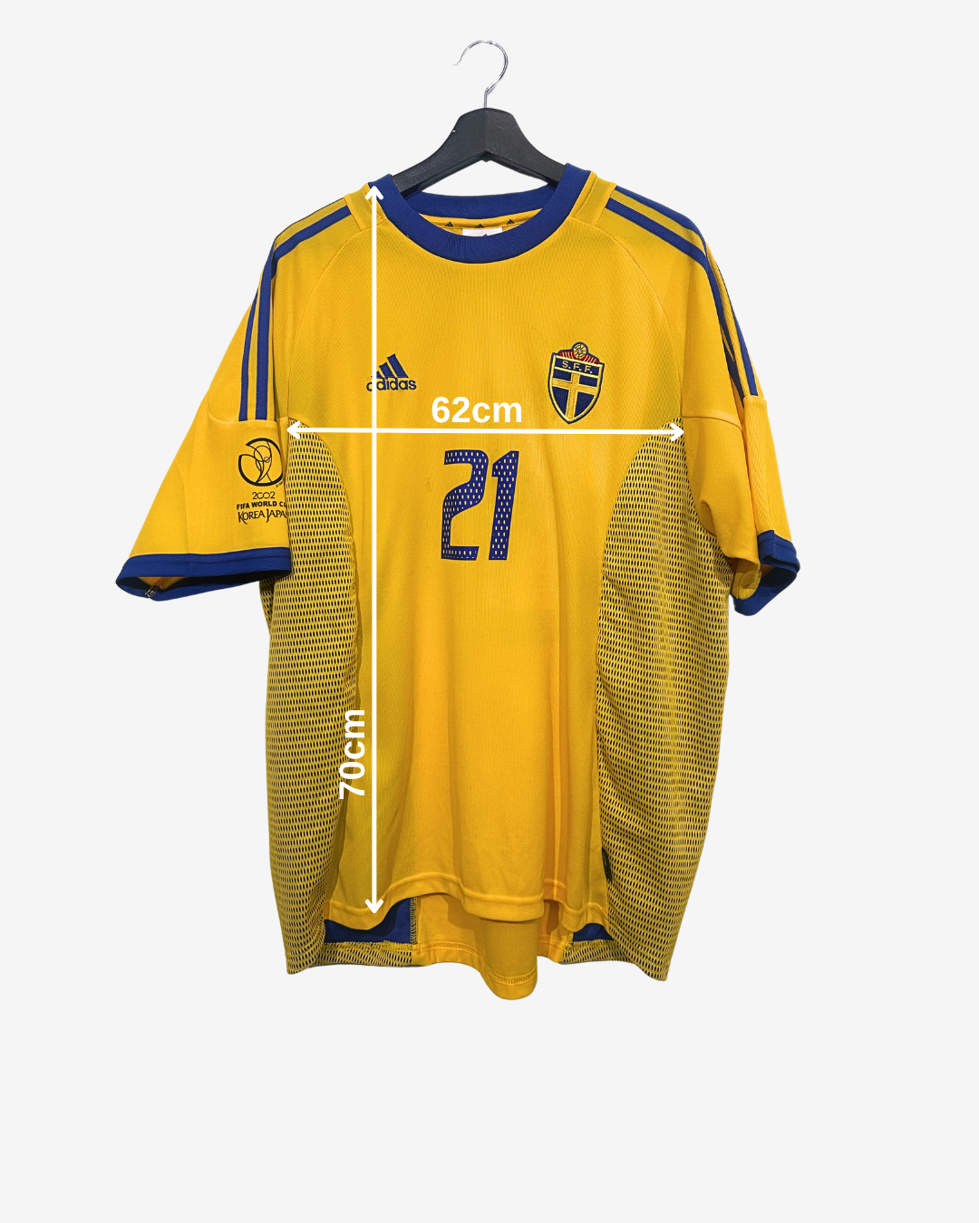 Yellow sports jersey with measurements on a hanger