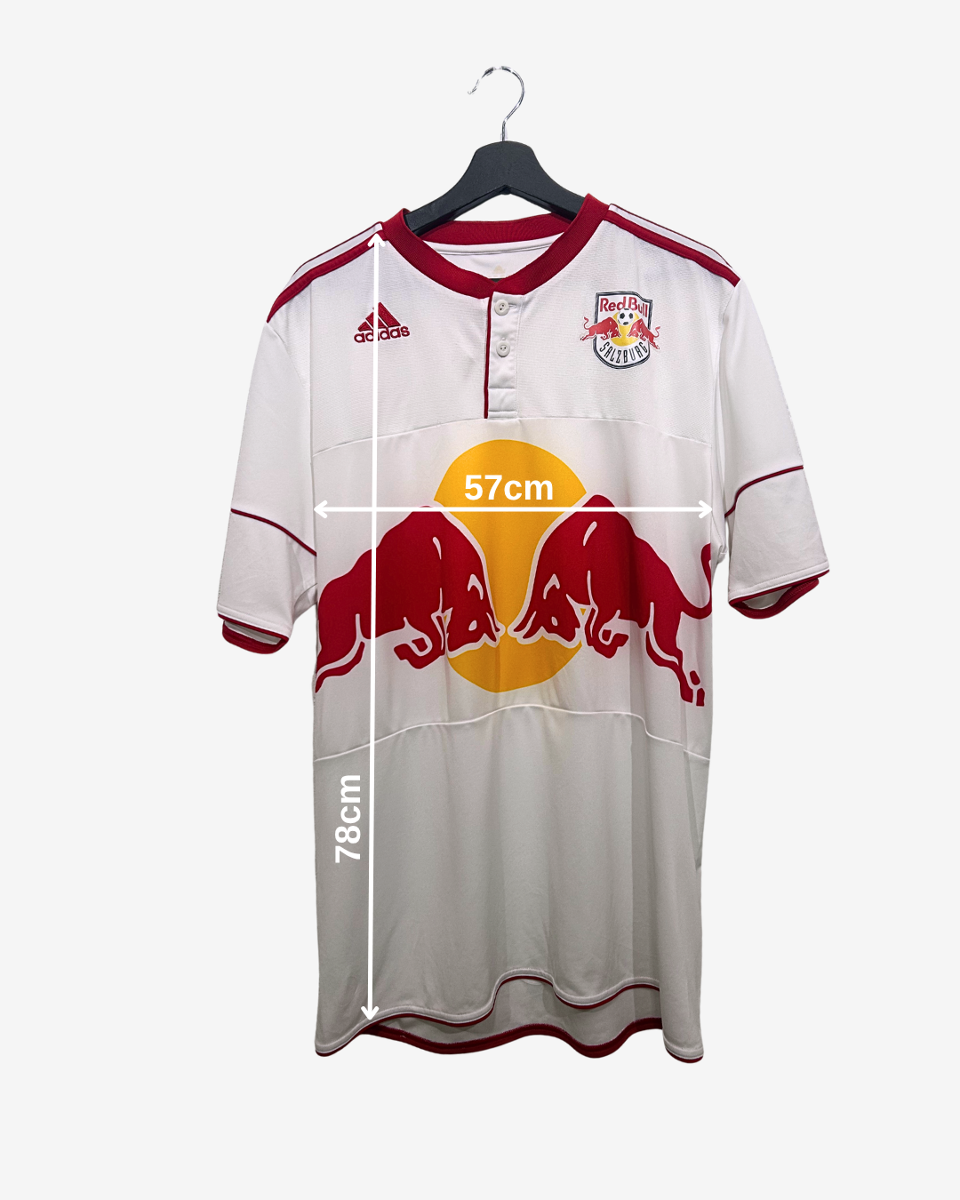 White sports jersey with red and yellow design on a hanger, showing measurements.