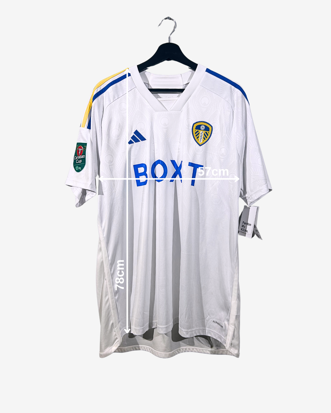 White sports jersey with branding on a hanger against a white background