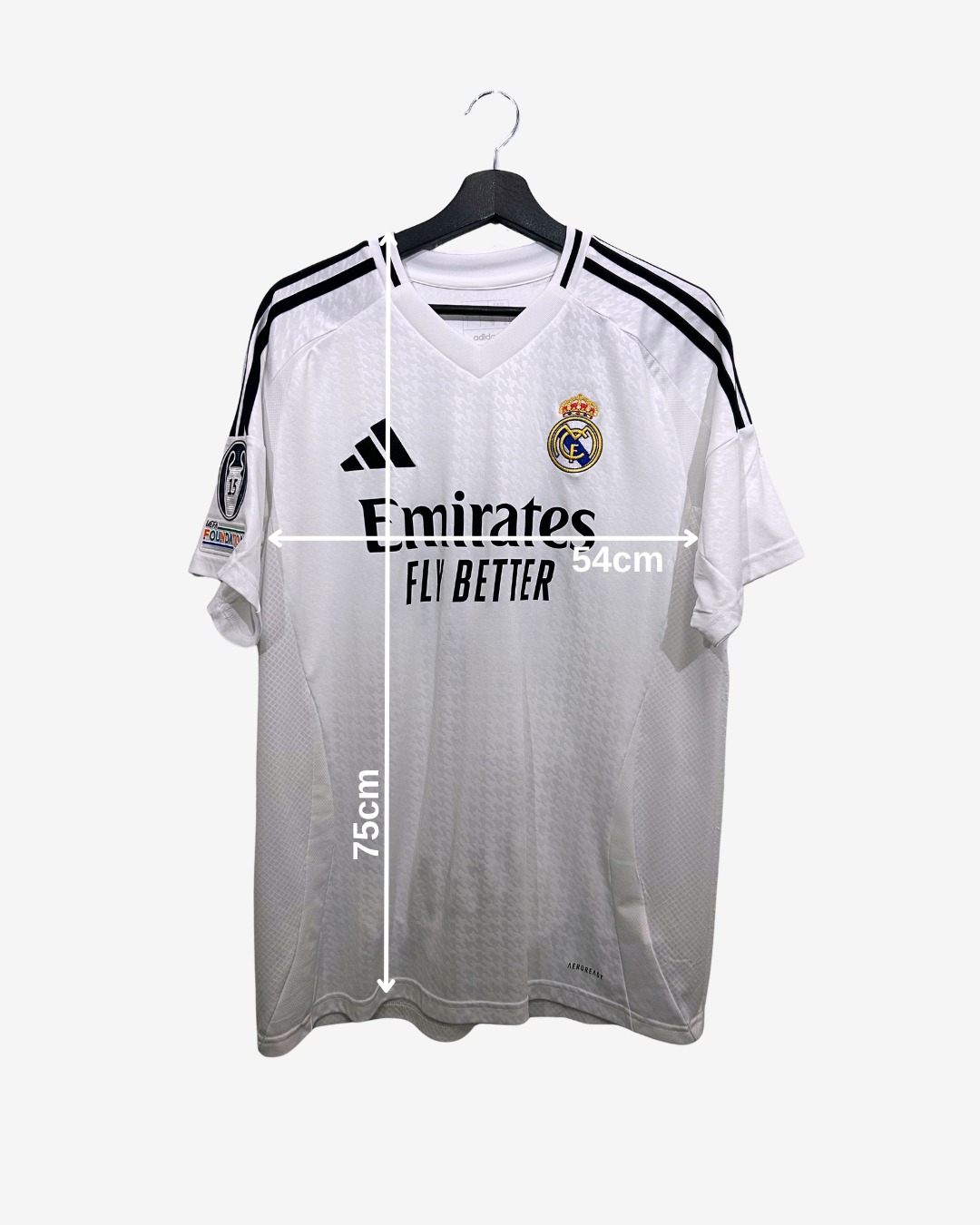 White sports jersey with black stripes on a hanger, featuring brand logos and measurements.