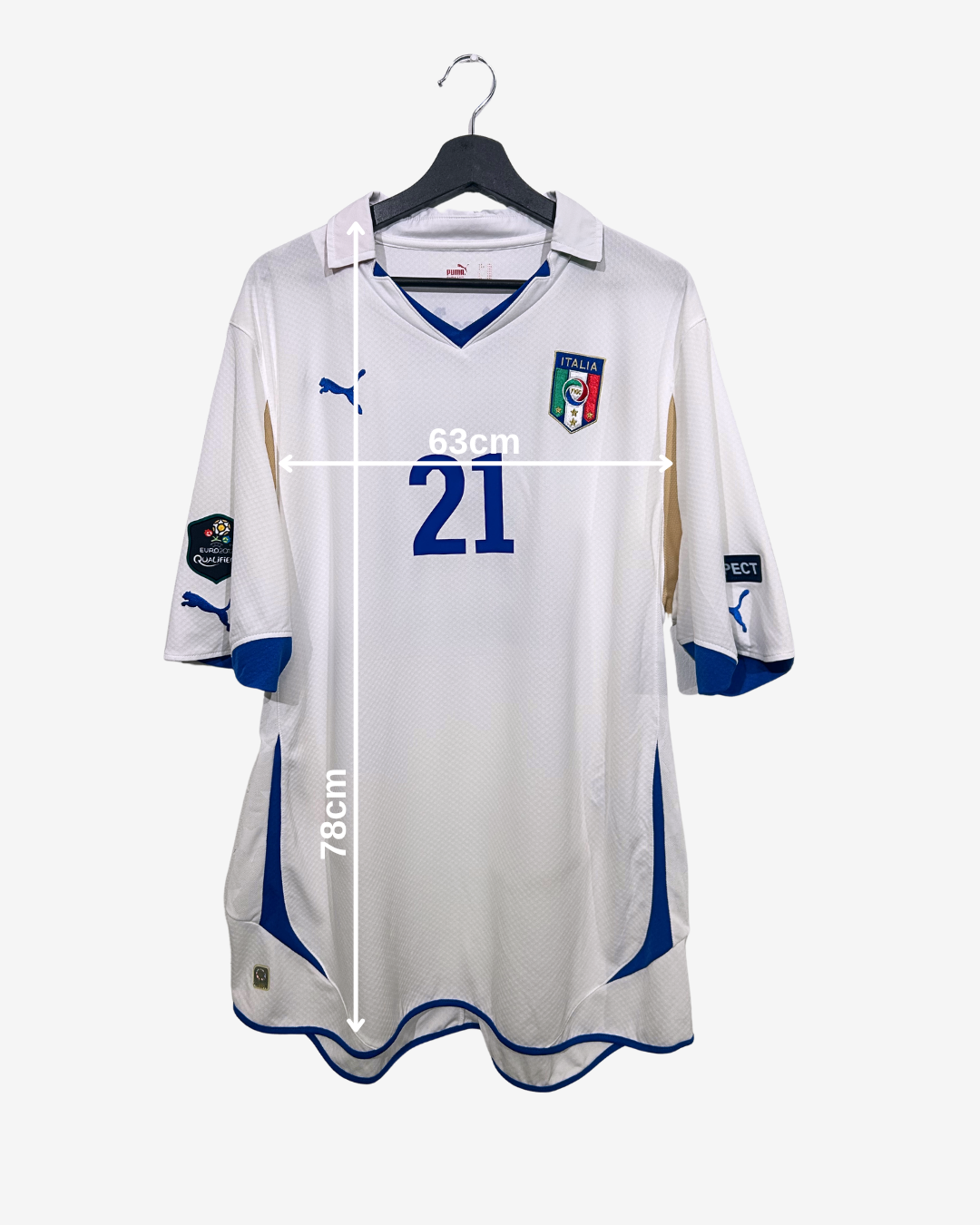 White soccer jersey with blue accents on a hanger, featuring measurements.