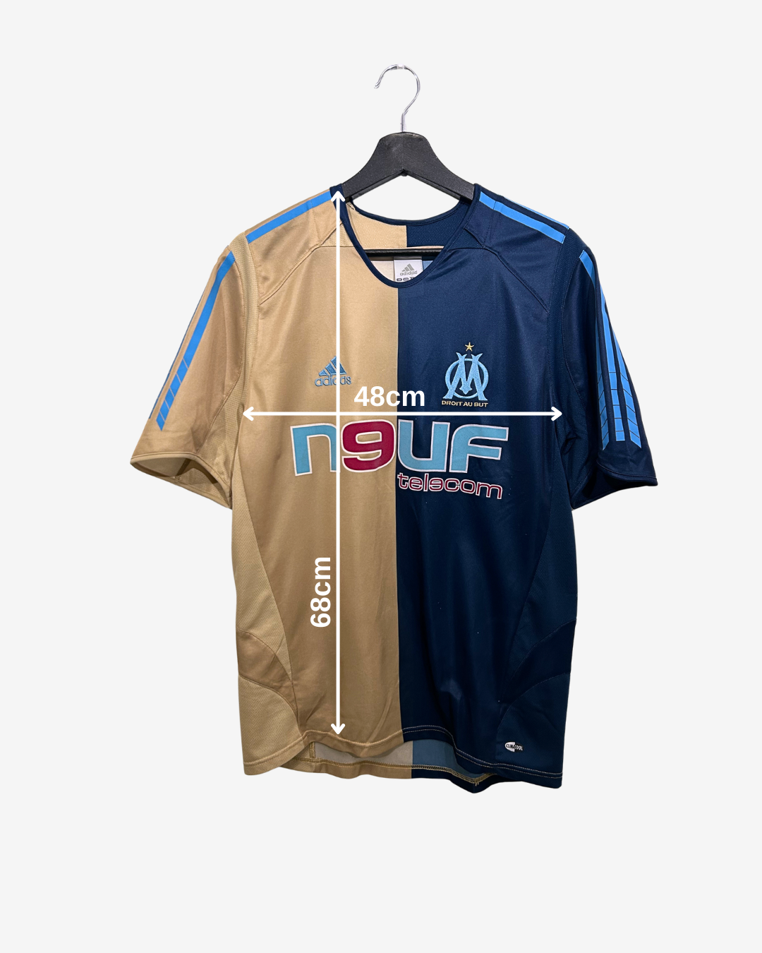 Two sports jerseys, one beige and one navy with blue accents, on a hanger with measurements indicated.