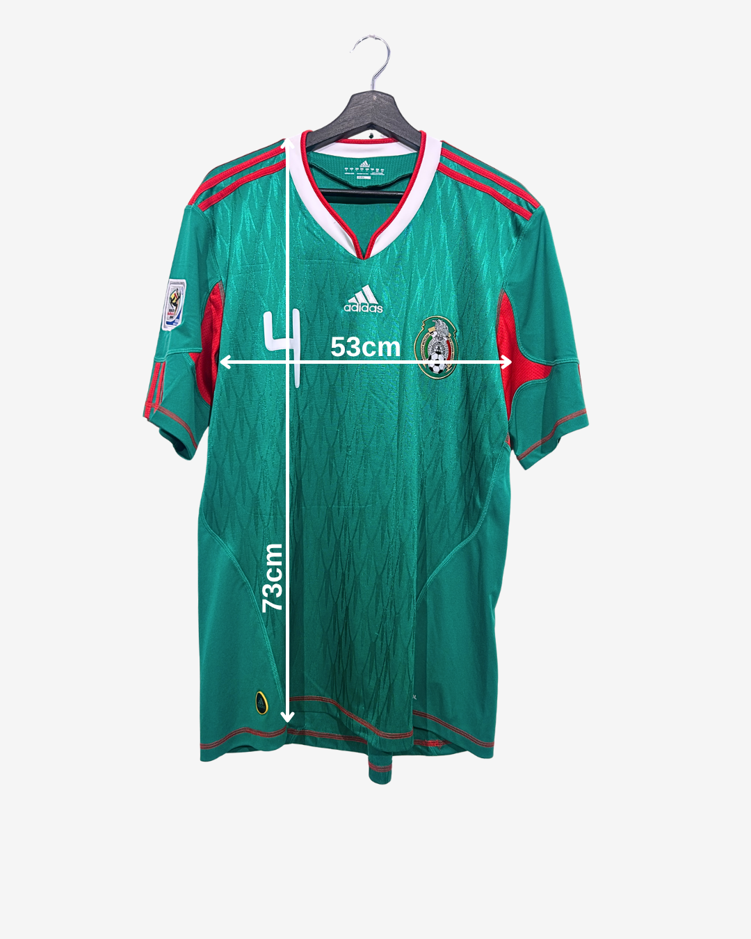 Green sports jersey with measurements on a white background