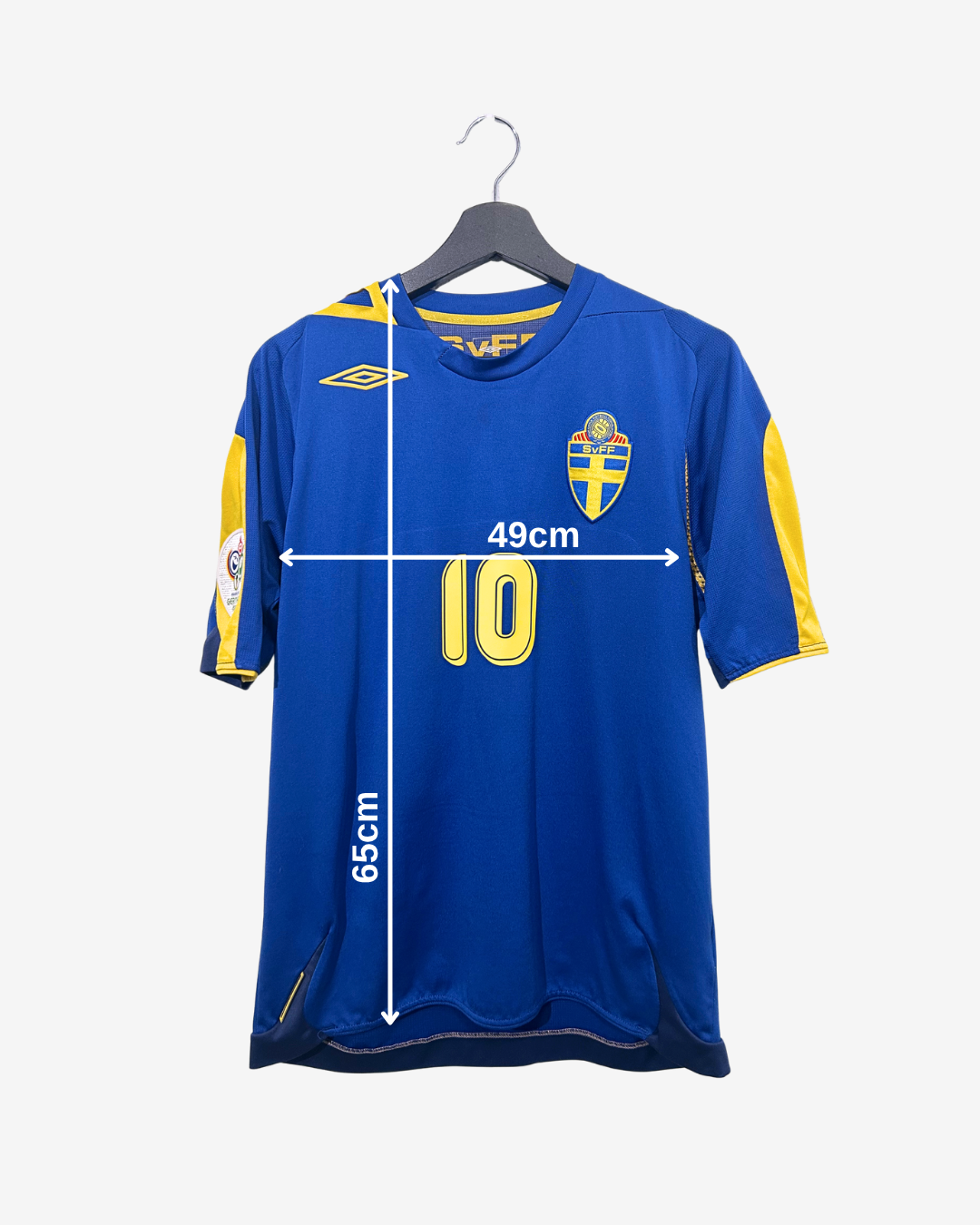 Blue sports jersey with yellow accents on a hanger, featuring measurements.