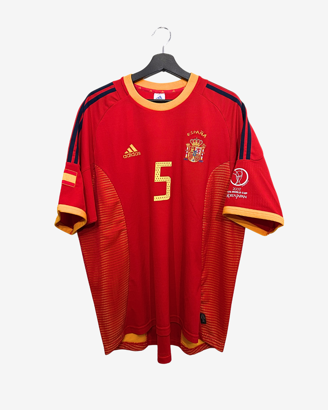 Red sports jersey with number 5 on a hanger against a white background