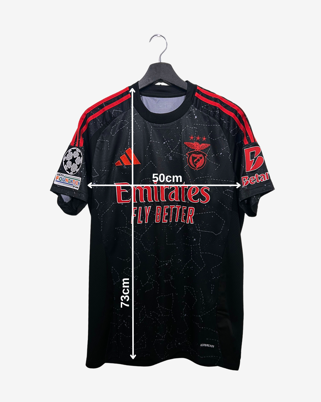 Black sports jersey with red accents on a hanger, featuring measurements and logos.