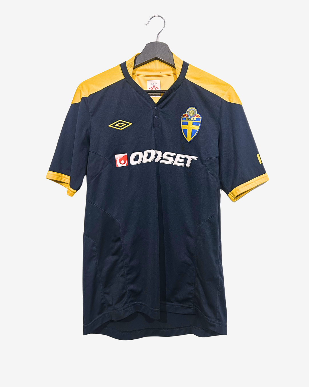 Navy and yellow sports jersey with visible branding on a white background