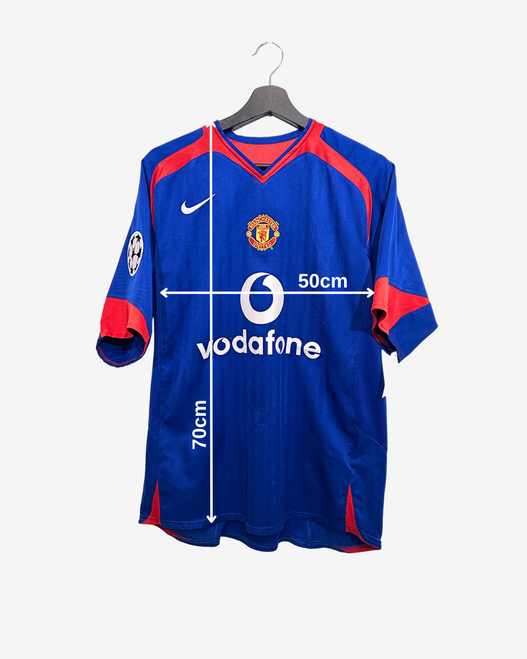 Blue sports jersey with red accents on a hanger, featuring branding and measurements.