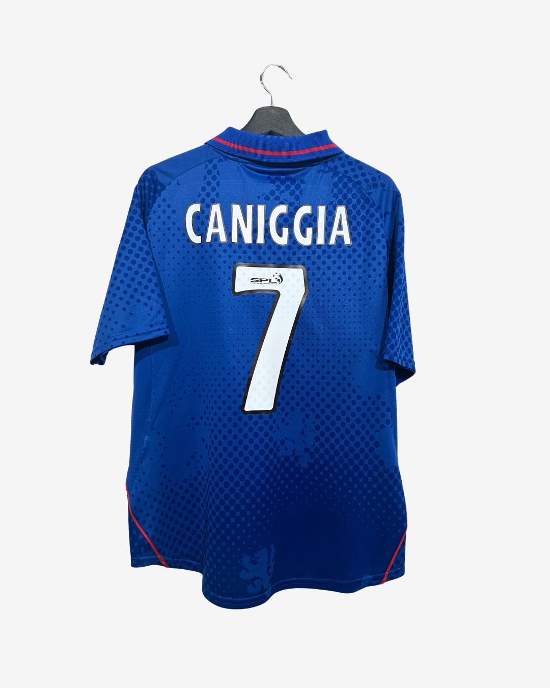 A blue Chelsea football jersey with 'CANIGGIA' and the number '7' printed on the back, hanging on a black hanger against a light gray background.