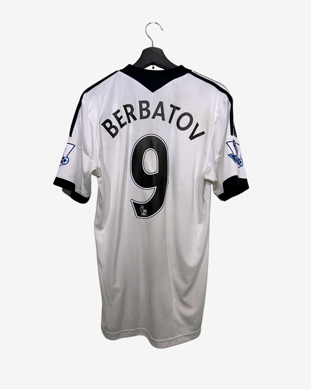 White sports jersey with black accents and 'Berbatov 9' printed on a white background
