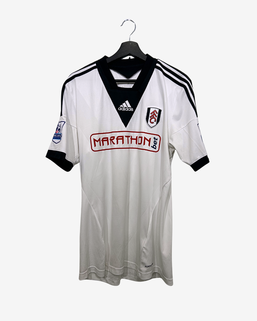 White sports jersey with black accents and visible branding on a white background