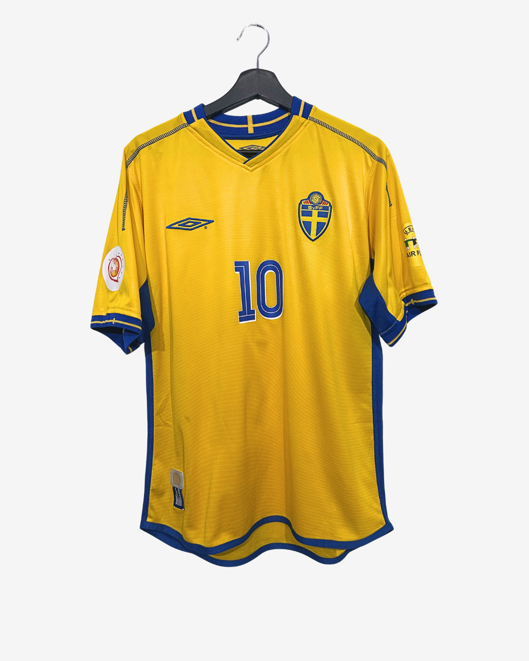 Yellow sports jersey with blue accents on a hanger against a white background