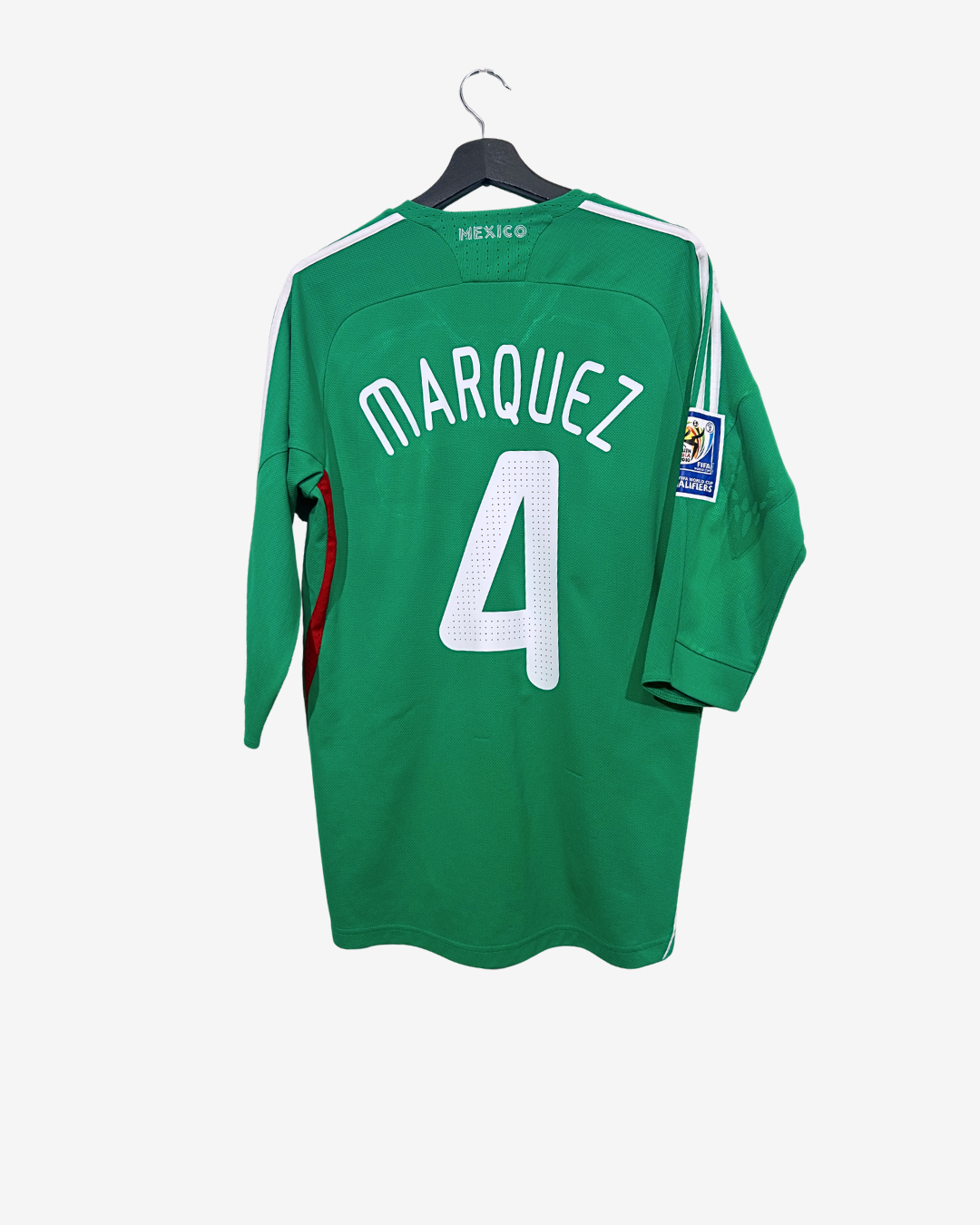 Green soccer jersey with 'Marquez 4' on a hanger against a white background