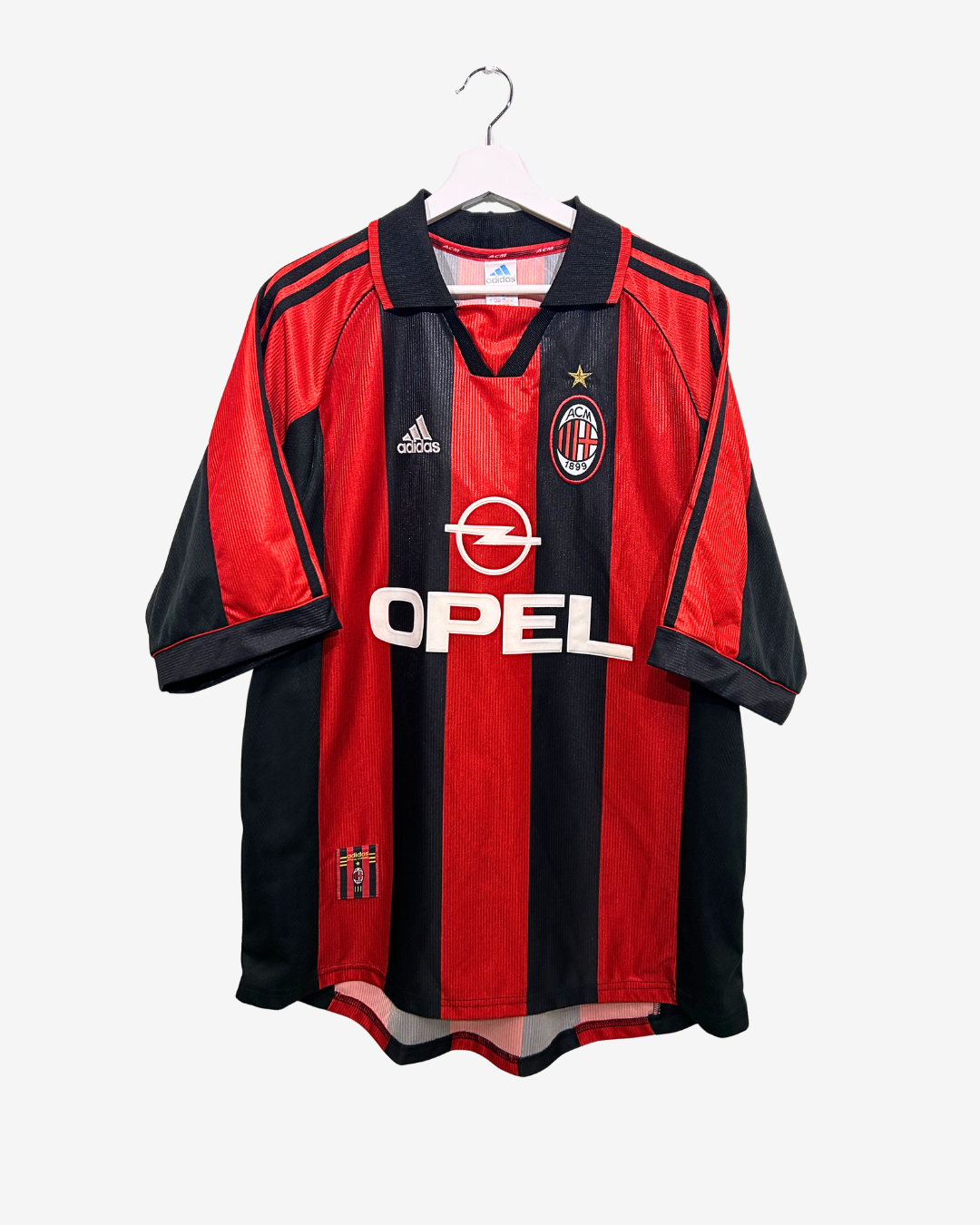 Red and black sports jersey with Opel logo on a white background