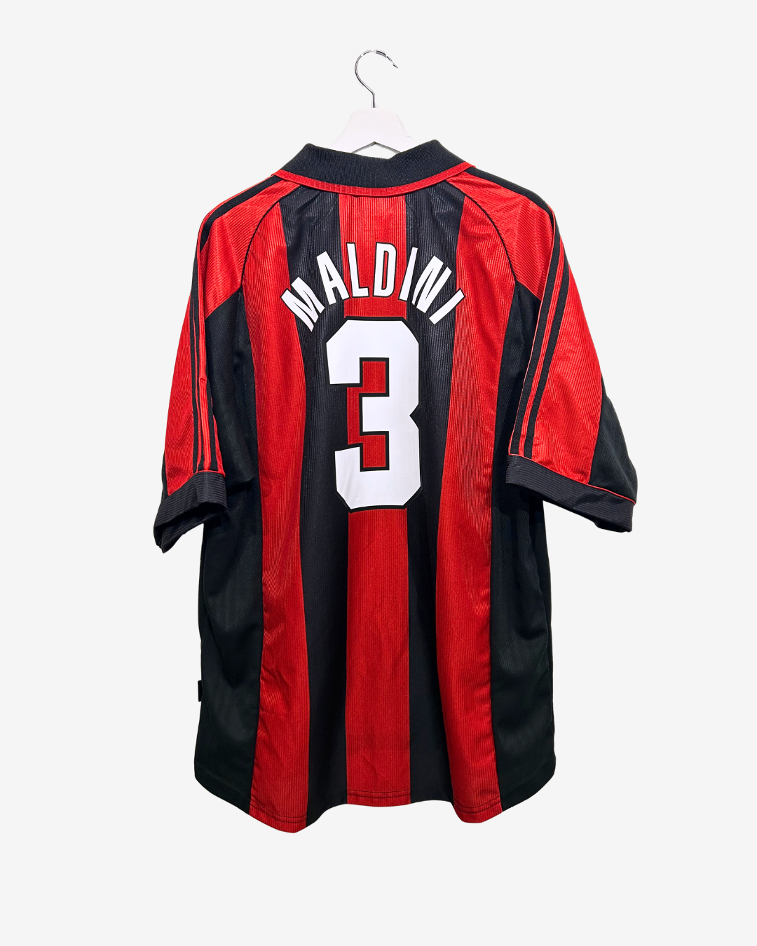 Red and black sports jersey with 'Maldini' and number '3' on a white background