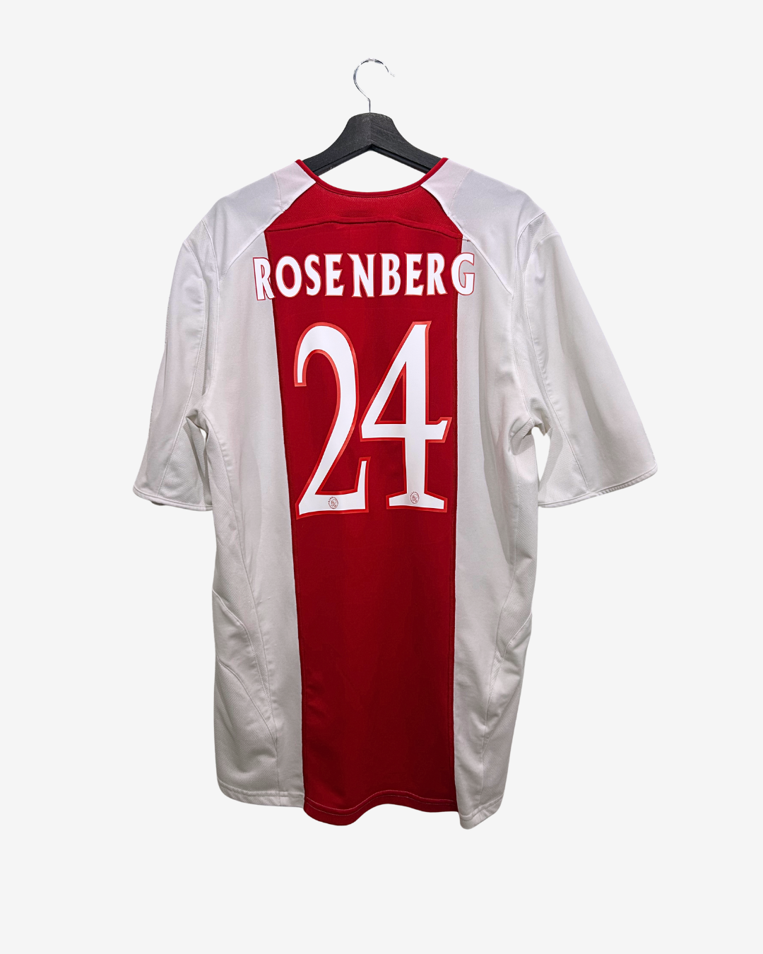 Red and white sports jersey with 'Rosenberg 24' on a hanger against a white background