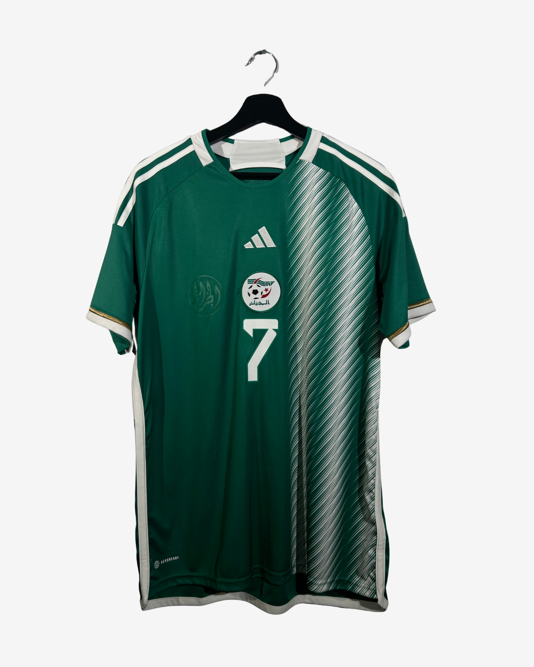 Green sports jersey with number 7 on a hanger against a white background