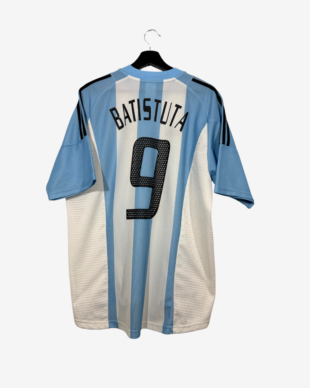 A light blue and white striped soccer jersey with 'BATISTUTA' and the number '9' printed on the back, hanging on a black hanger against a light gray background.