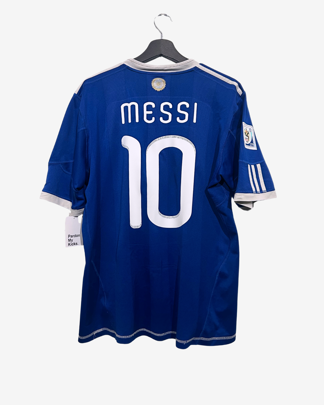 Blue sports jersey with 'Messi 10' on a hanger against a white background