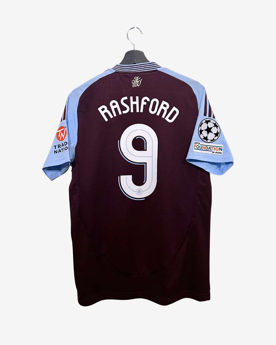 Maroon sports jersey with 'Rashford' and number '9' on a hanger against a white background
