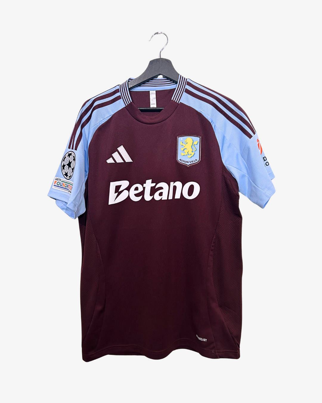 Maroon sports jersey with light blue sleeves on a hanger against a white background