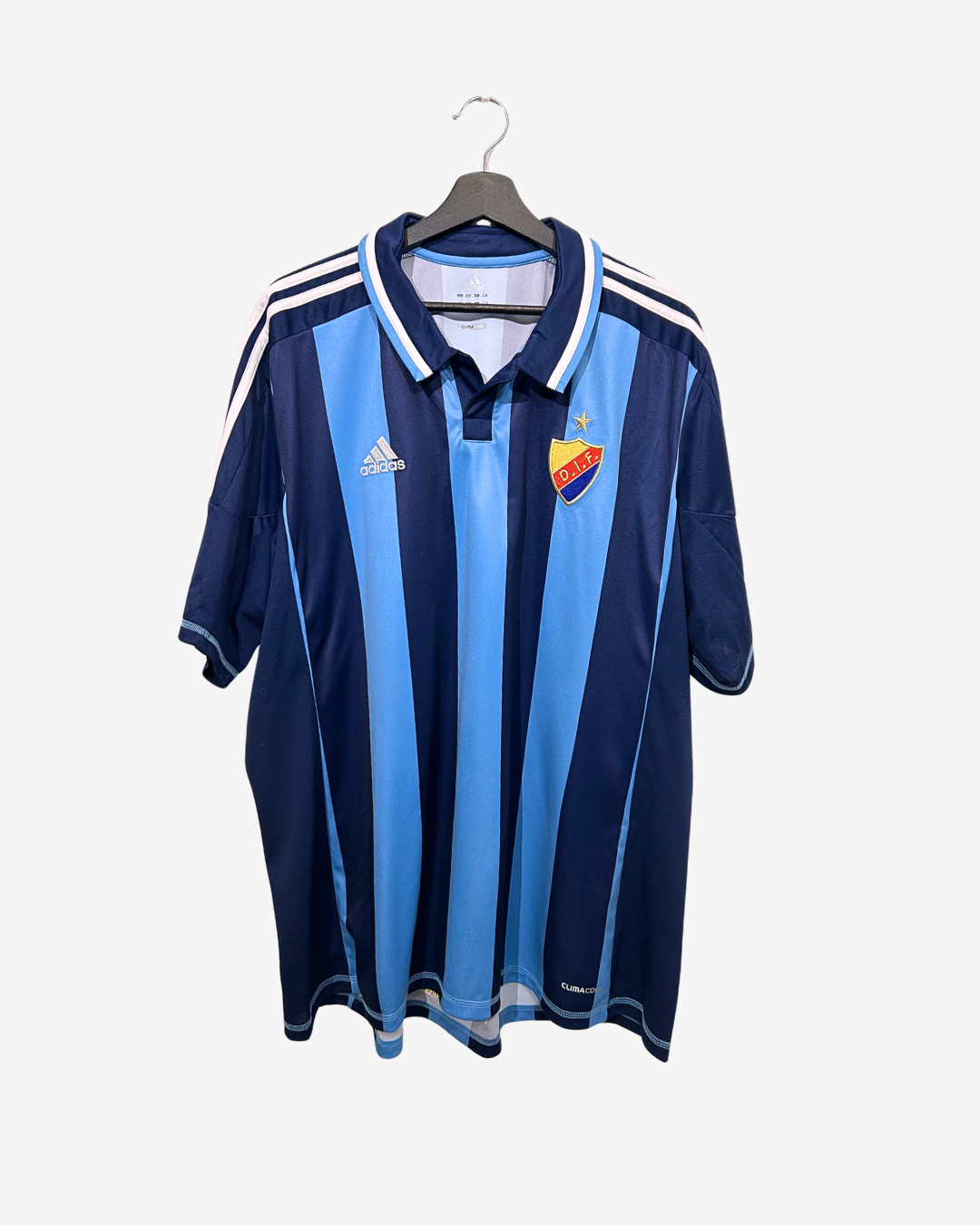 Blue and navy striped sports jersey with Adidas logo on a hanger against a white background