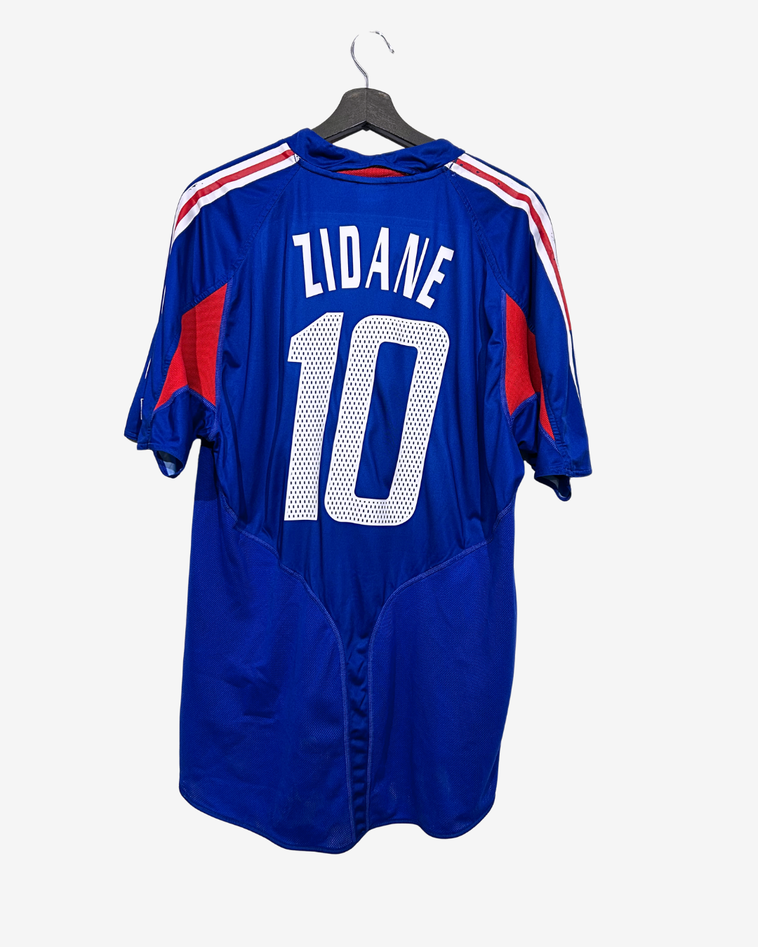 Blue sports jersey with 'Zidane' and number '10' on a hanger against a white background