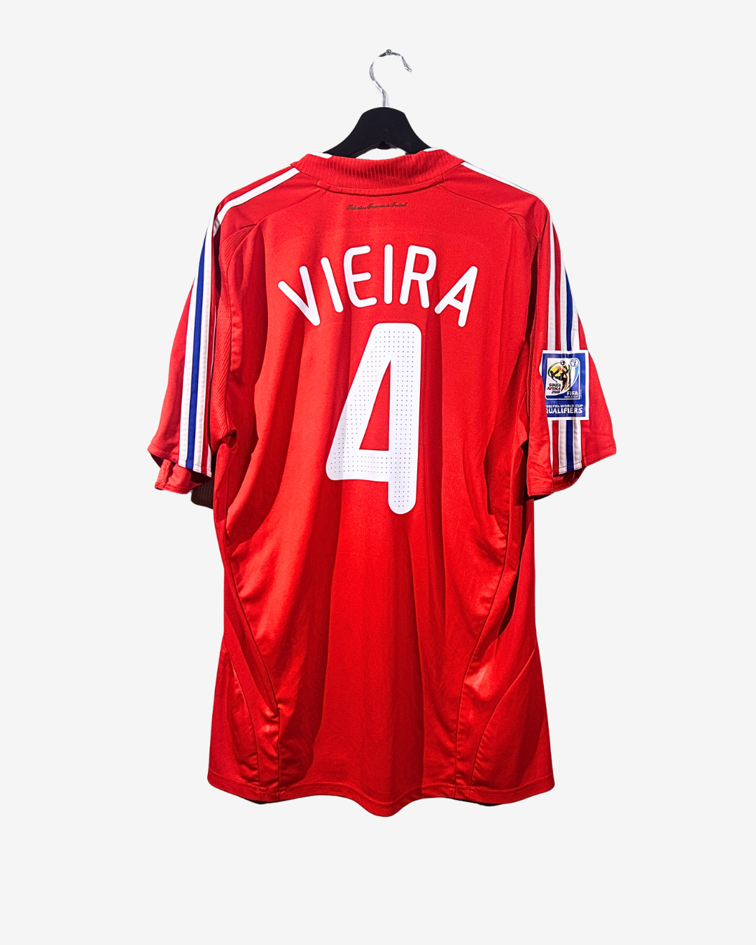 Red sports jersey with 'Vieira 4' on a white background