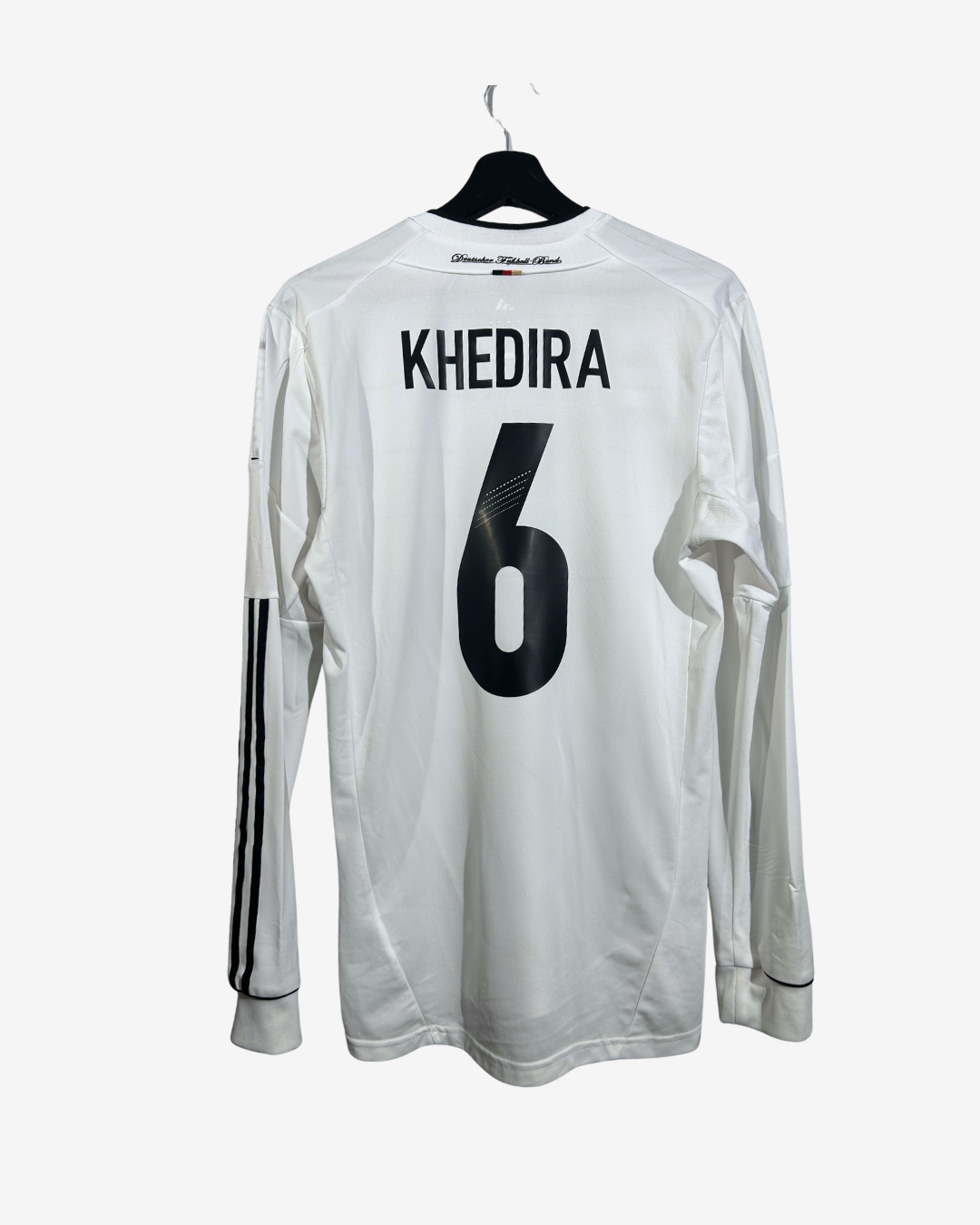 A white long-sleeve soccer jersey with 'KHEDIRA' and the number '6' printed in black on the back, hanging on a black hanger against a light gray background.