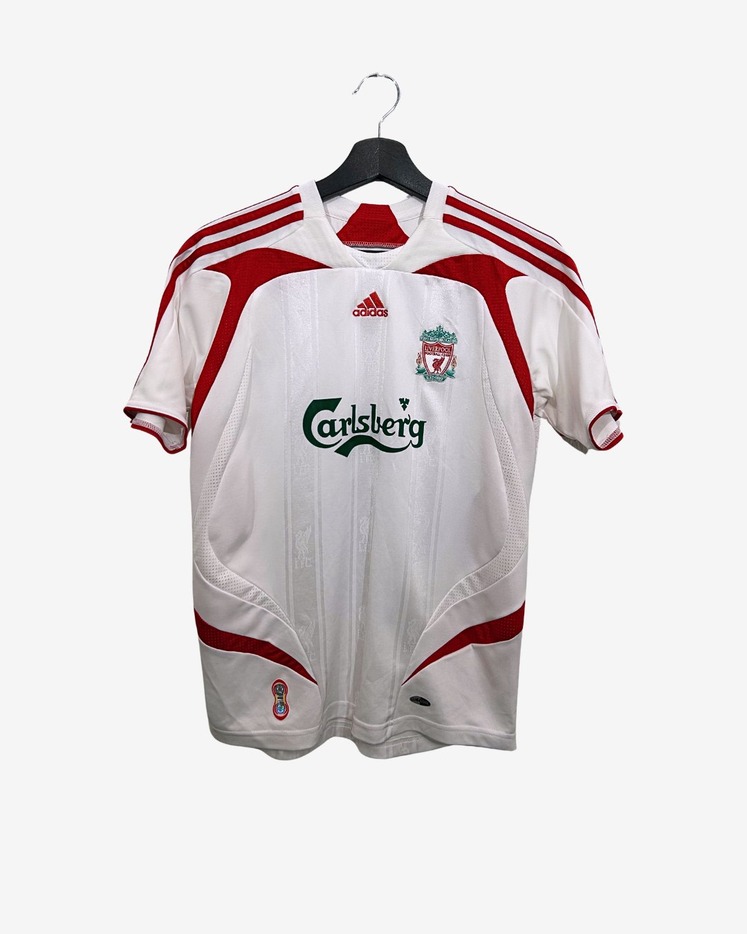 White sports jersey with red accents on a hanger against a white background