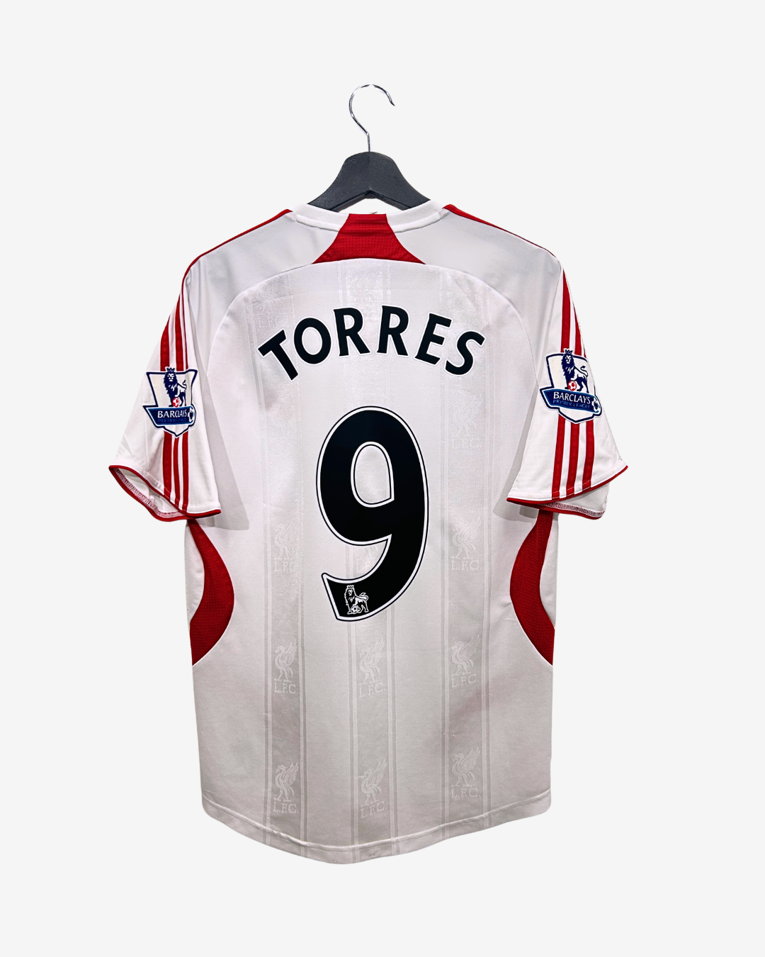 White sports jersey with red accents, featuring the name 'Torres' and number '9', on a hanger against a white background.