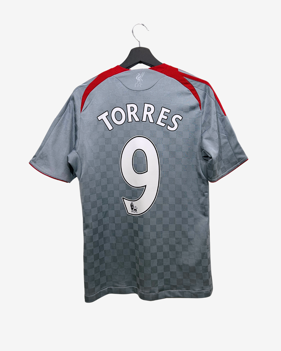 Gray sports jersey with 'TORRES' and number '9' on a hanger against a white background