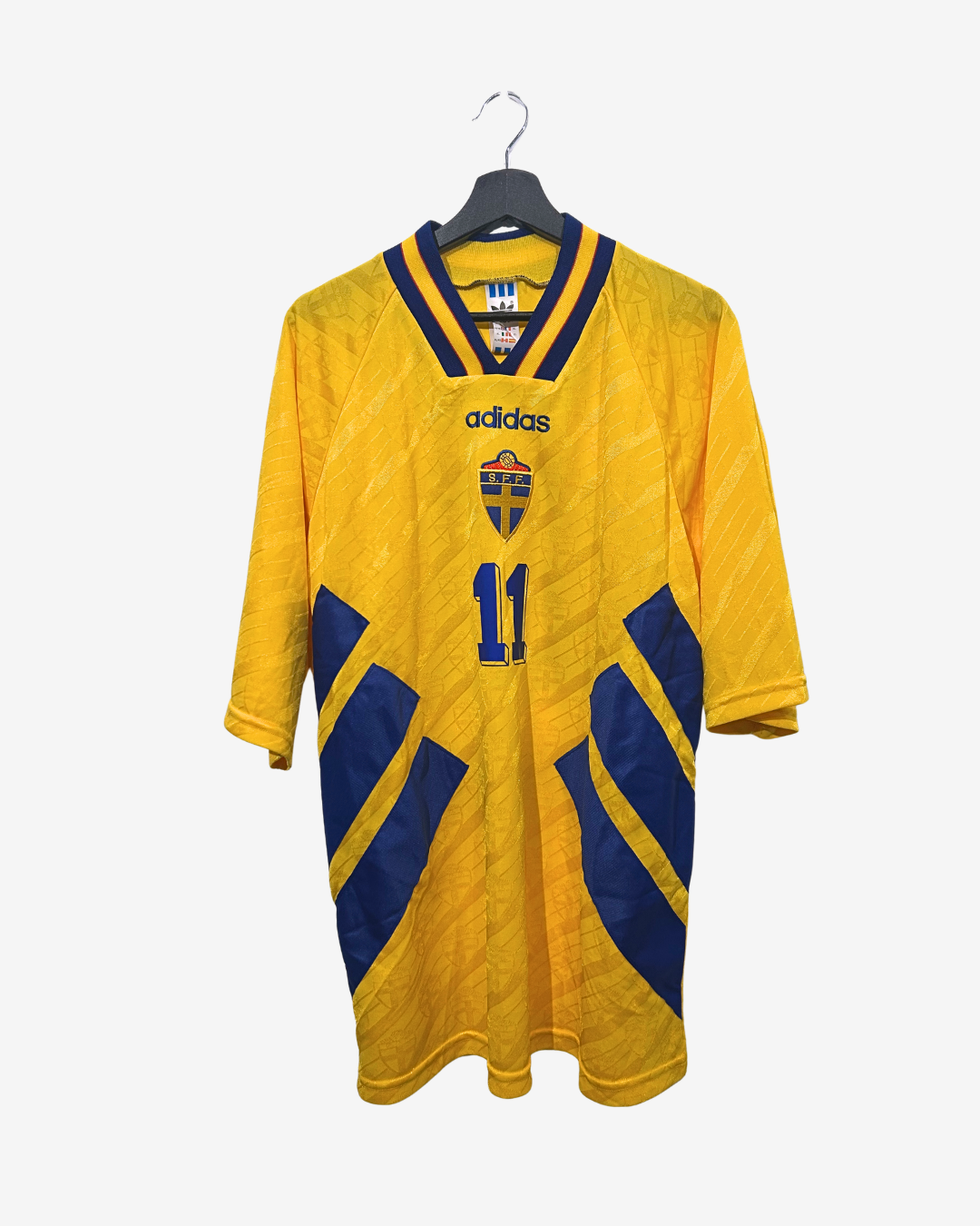 Yellow soccer jersey with blue accents and Adidas logo on a hanger against a white background