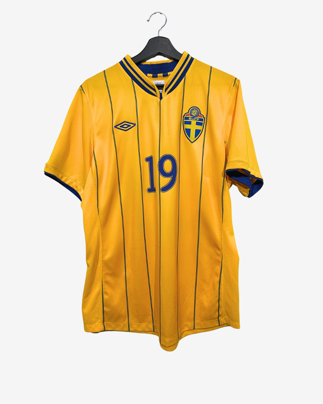 Yellow sports jersey with number 19 and emblem on a hanger against a white background