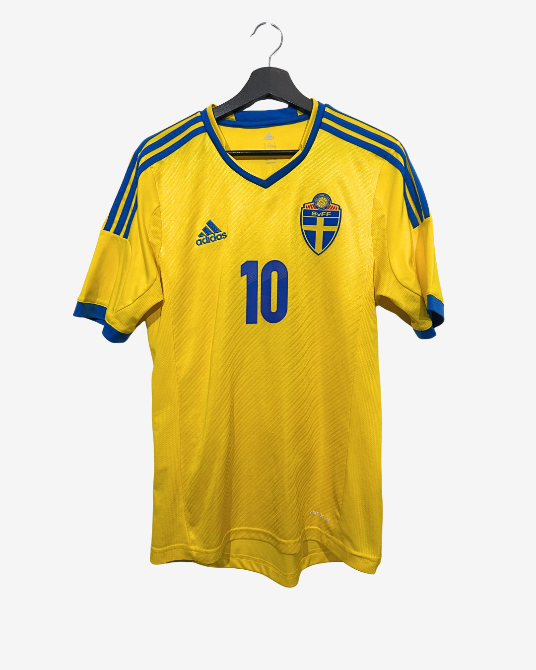 Yellow sports jersey with blue accents and number 10, featuring an Adidas logo, on a hanger against a white background.