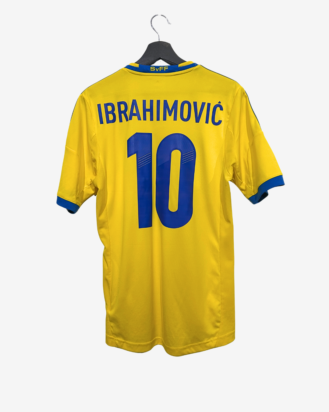 Yellow sports jersey with 'Ibrahimovic' and number '10' on a hanger against a white background