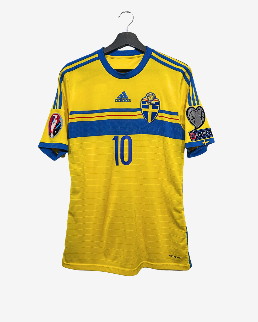 Yellow soccer jersey with blue accents on a hanger