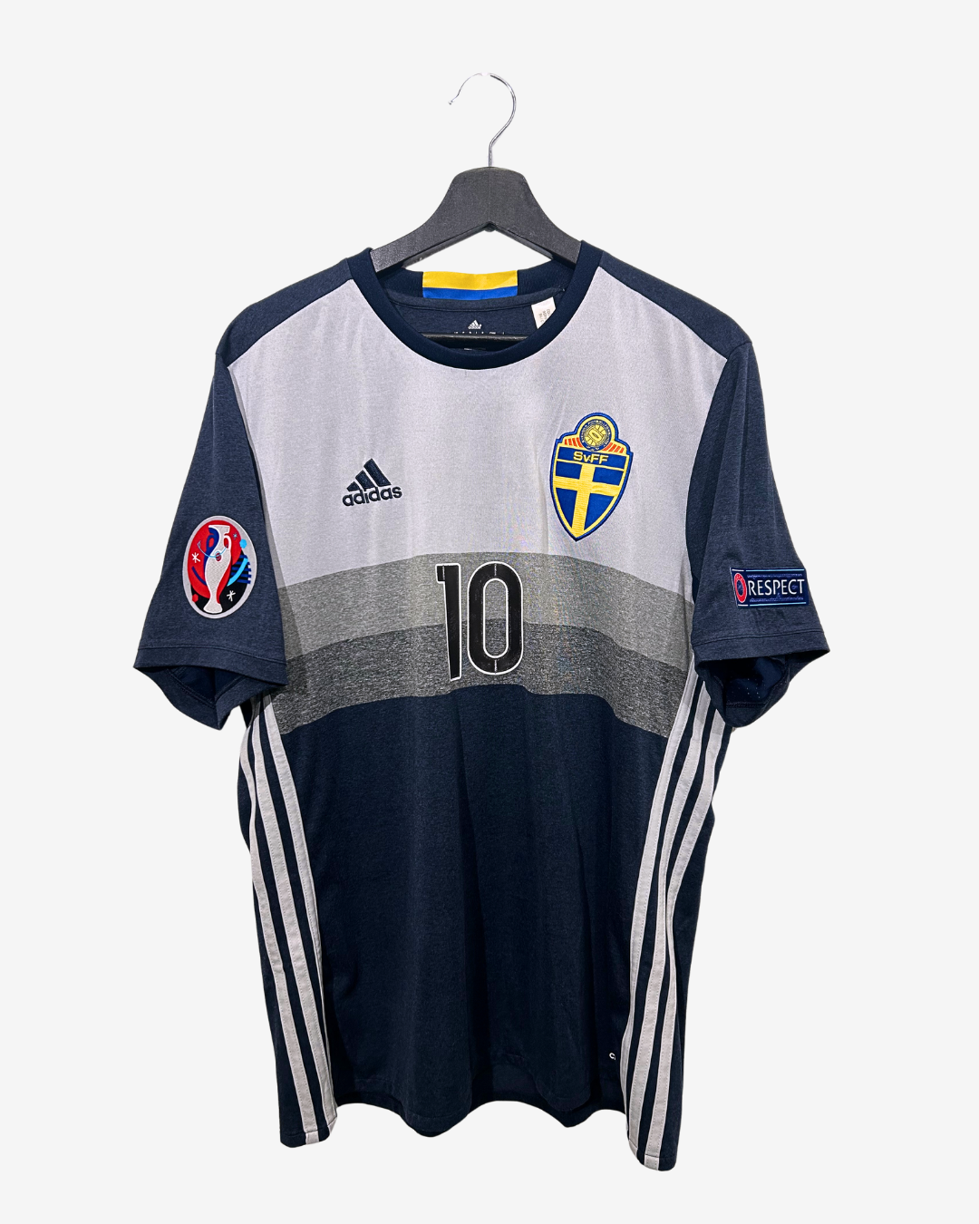 Navy and gray sports jersey with number 10 on a hanger against a white background