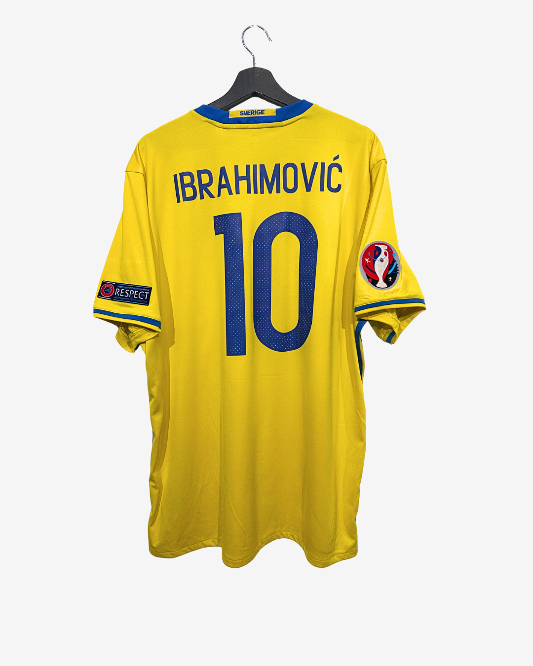 Yellow sports jersey with 'Ibrahimovi|' and number '10' on a hanger against a white background