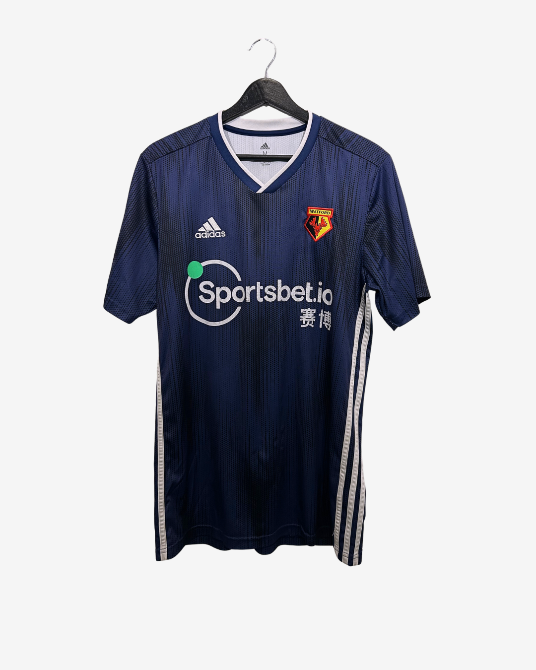Navy blue sports jersey with Adidas and Sportsbet.io logos on a hanger
