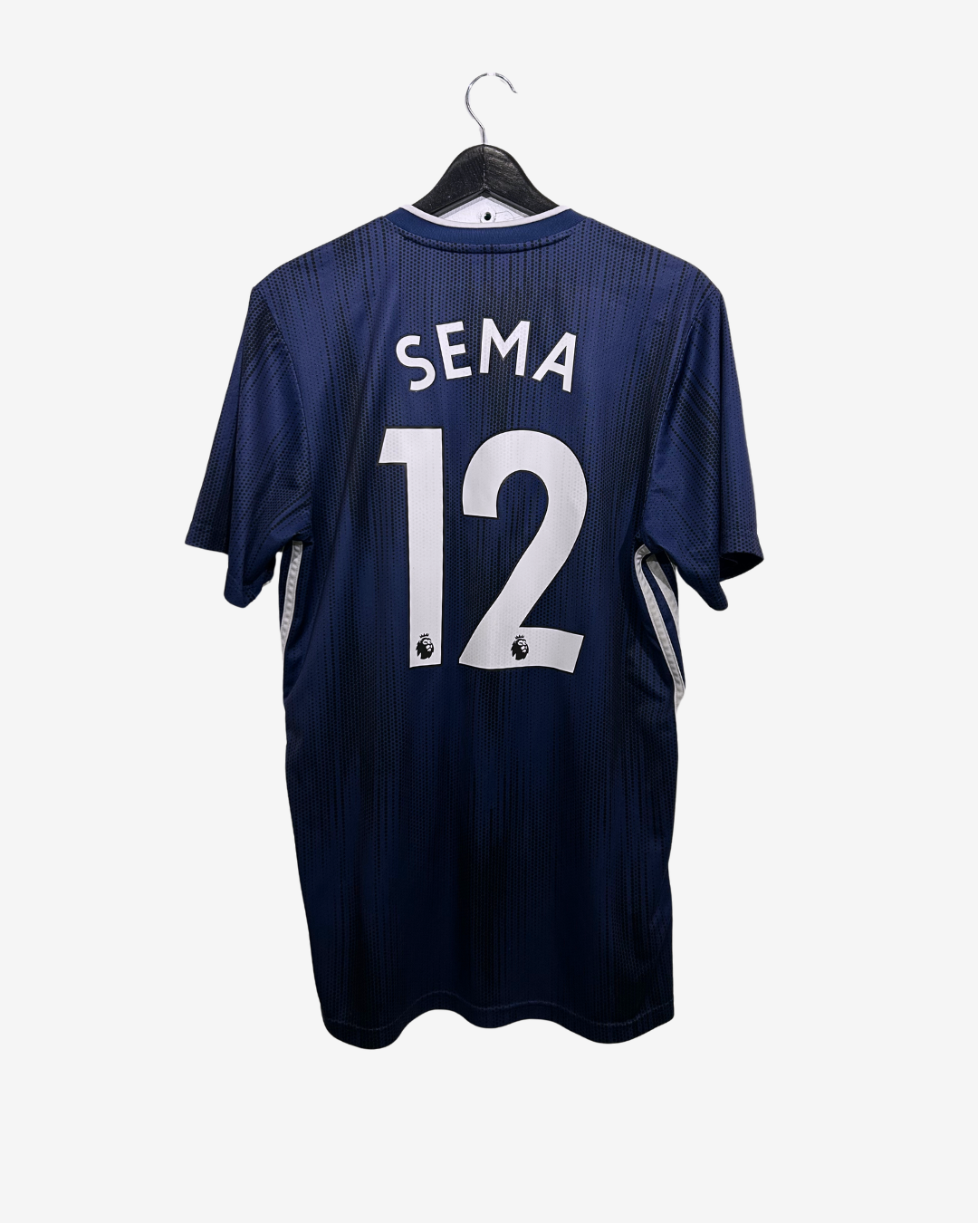 Navy blue sports jersey with 'SEMA' and number '12' on a white background