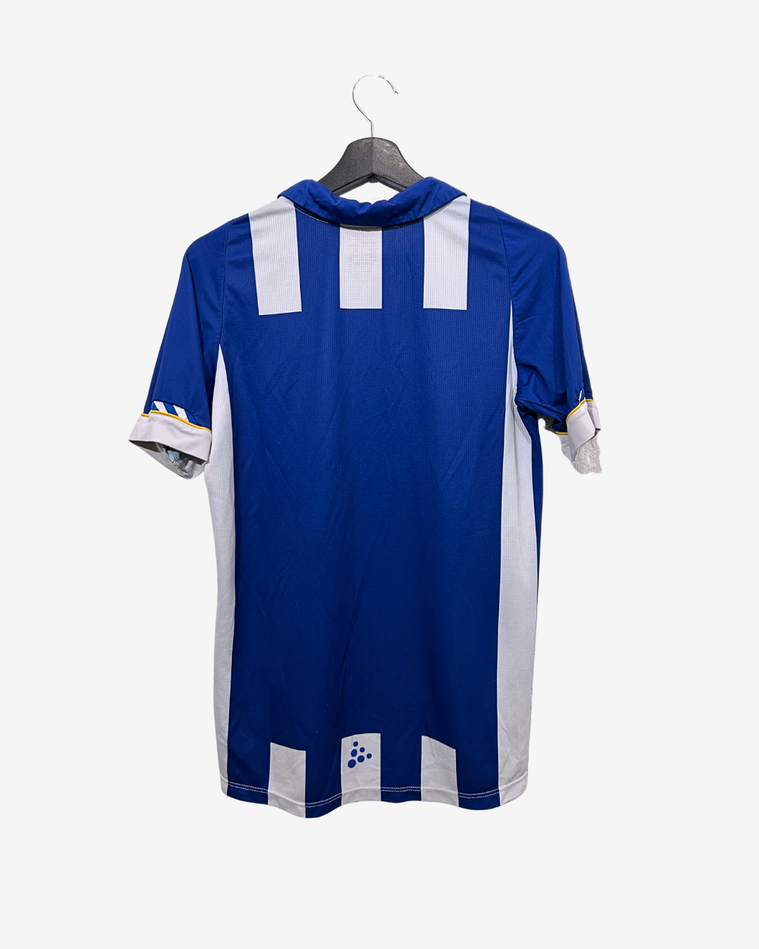 Blue sports jersey with white accents on a hanger against a white background